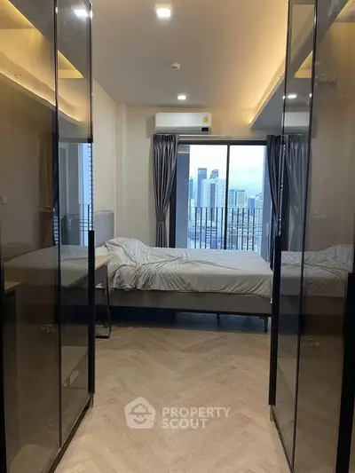 Modern bedroom with city view and sleek glass wardrobes