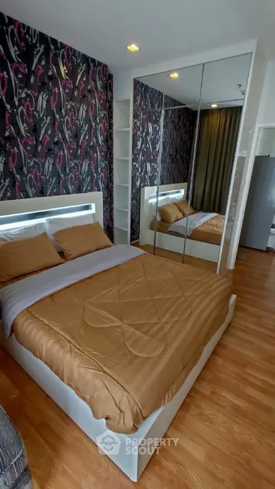 Stylish bedroom with mirrored wardrobe and modern decor