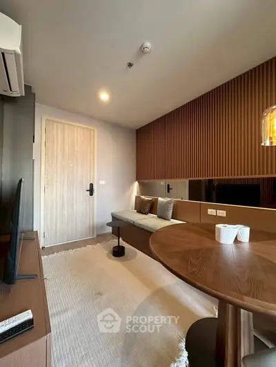 Modern living room with stylish wood accents and cozy seating area, perfect for relaxation and entertainment.