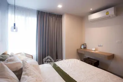 Cozy bedroom with modern decor and air conditioning, perfect for relaxation.