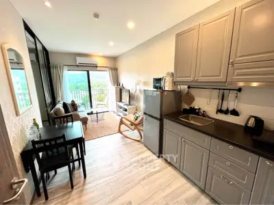 Modern open-layout kitchen and living room with scenic balcony view