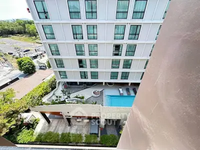 Modern apartment building with pool and lush greenery, offering a serene urban living experience.