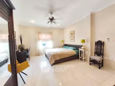 Spacious bedroom with elegant decor and natural light