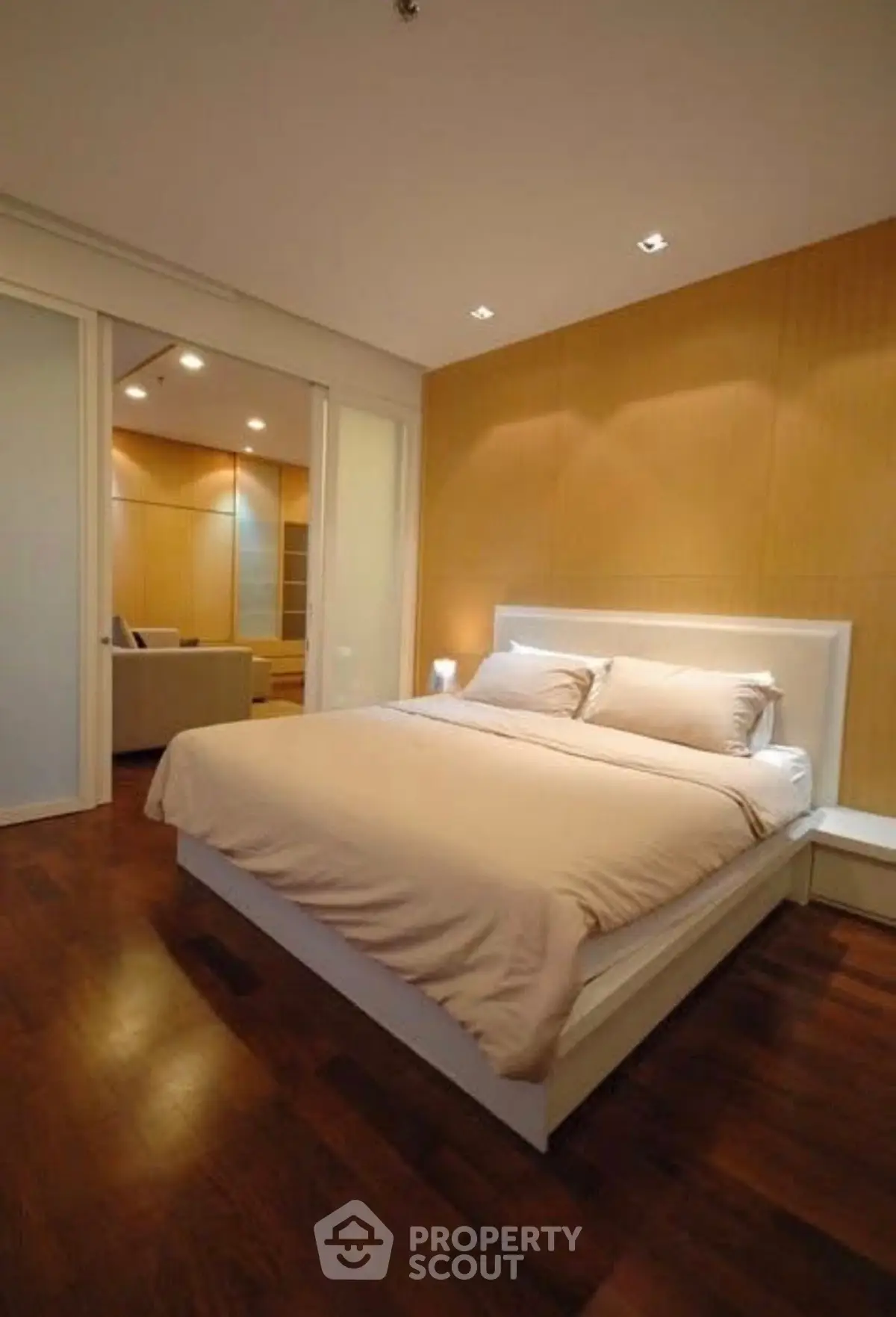Luxurious bedroom with elegant wooden flooring and ambient lighting