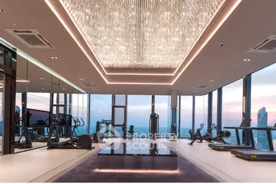 Luxurious high-rise gym with panoramic city views and modern fitness equipment.