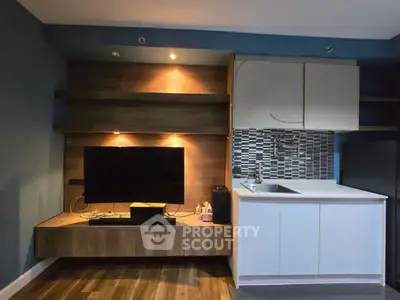 Modern living room with sleek TV unit and stylish kitchen area