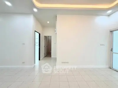 Spacious modern living room with recessed lighting and tiled flooring