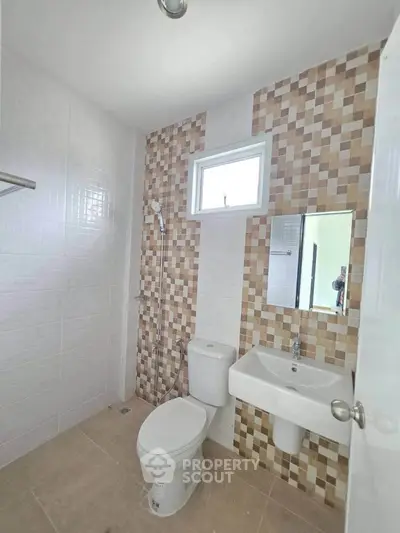 Modern bathroom with stylish tile design and compact fixtures