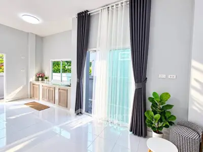Bright and spacious living room with large windows and modern decor