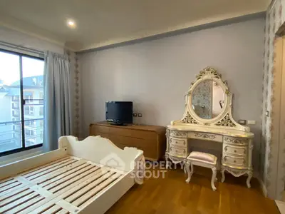 Elegant bedroom with vintage dresser and balcony view in luxury apartment