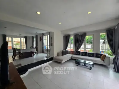 Spacious living room with modern decor and large windows for natural light