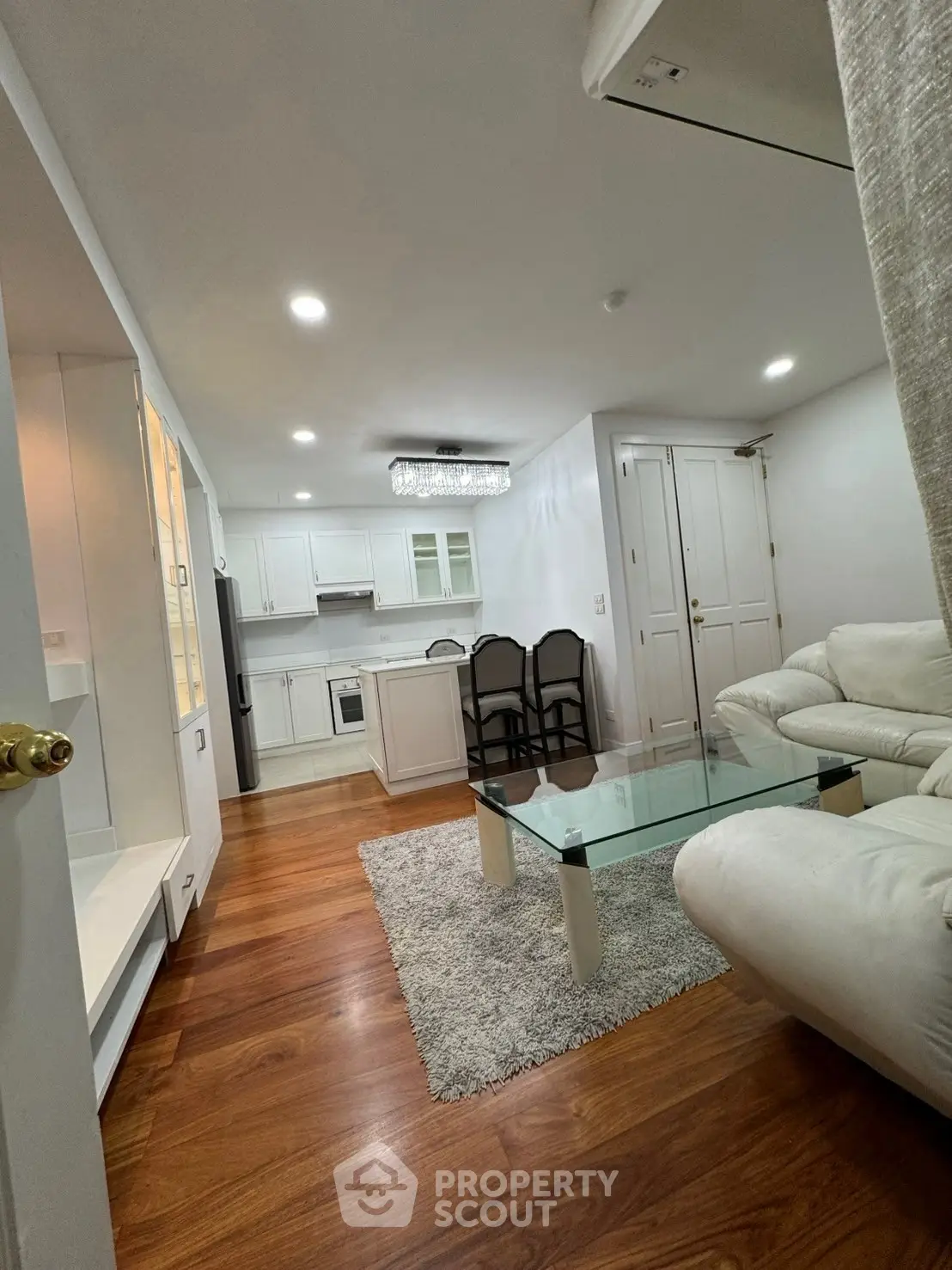 Chic open-plan living room with modern kitchen and elegant furnishings
