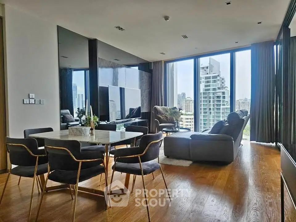 Luxurious living room with stunning city view, modern furniture, and floor-to-ceiling windows in high-rise apartment.