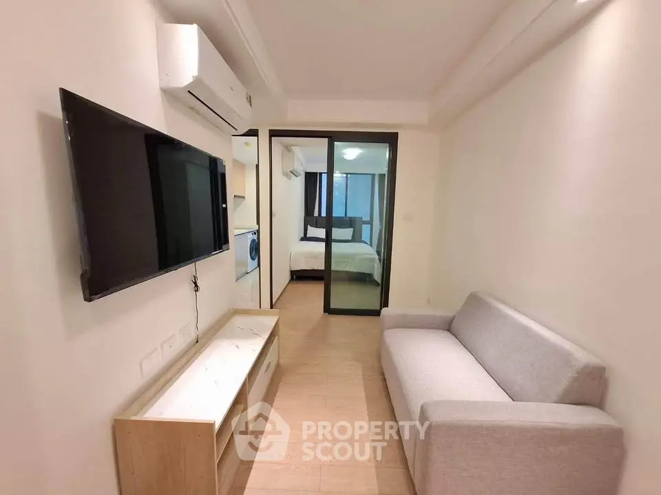 Modern living room with sleek TV and cozy sofa in a stylish apartment