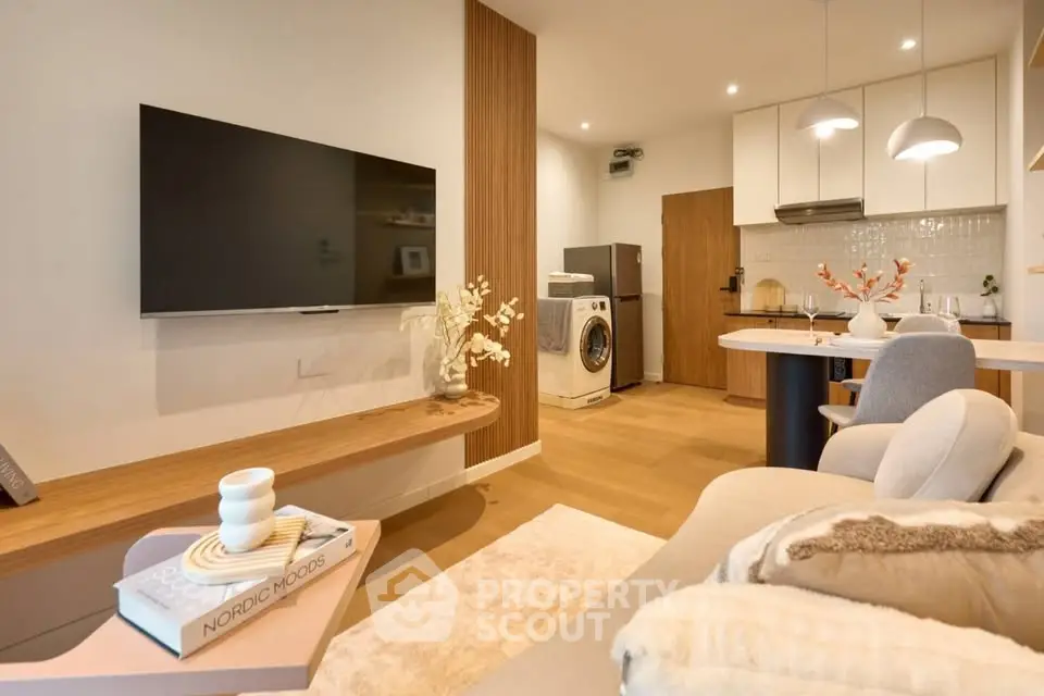 Modern living room with open kitchen, featuring sleek design and cozy ambiance, perfect for urban living.