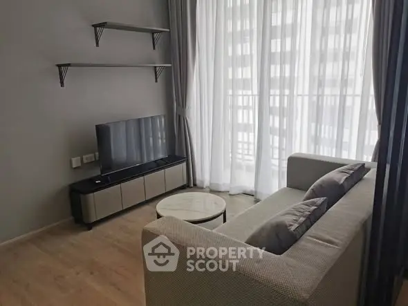 Modern living room with sleek furniture and large window for natural light