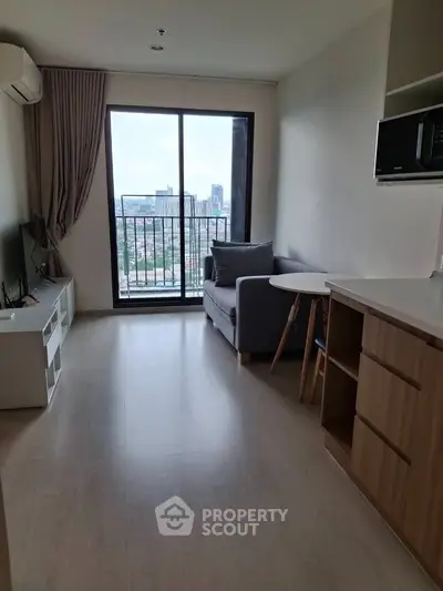 Modern living room with city view, featuring sleek furniture and natural light.
