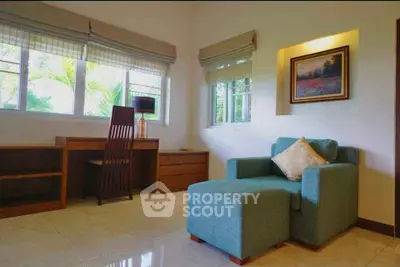 Spacious living room with modern furniture and large windows offering natural light