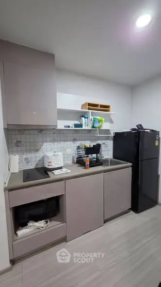 Modern kitchen with sleek cabinetry and appliances in a stylish apartment.