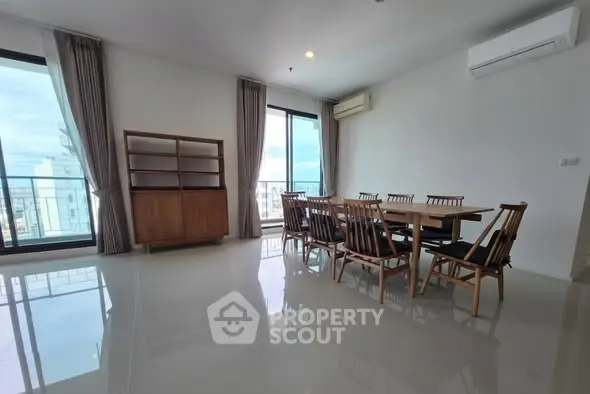 Spacious dining area with large windows and modern furniture