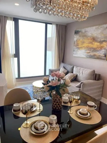 Luxurious living room with elegant dining setup and stunning chandelier