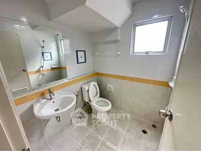 Spacious bathroom with modern fixtures and natural light