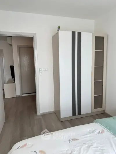 Modern bedroom with sleek wardrobe and minimalist decor