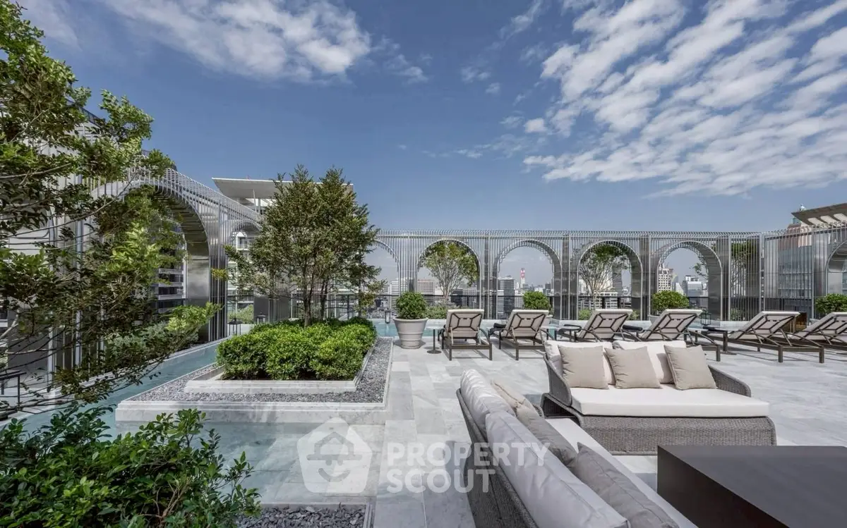 Luxurious rooftop terrace with modern lounge furniture and stunning city views.