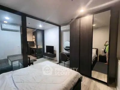 Modern bedroom with glass partition and stylish furniture in a cozy apartment