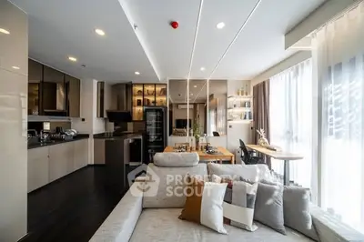 Spacious modern living room with open kitchen and large windows in luxury apartment.