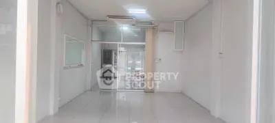 Spacious commercial space with glass doors and tiled flooring, ideal for retail or office setup.