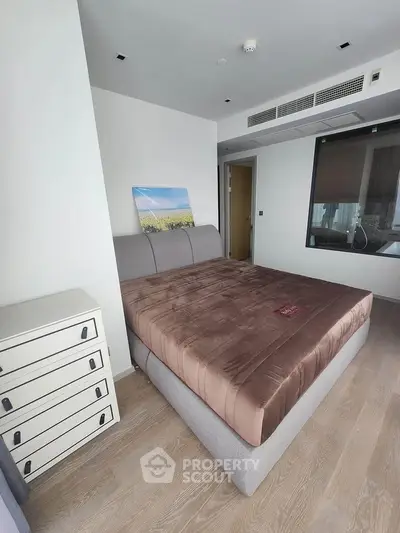 Spacious bedroom with modern decor and large bed in a stylish apartment.