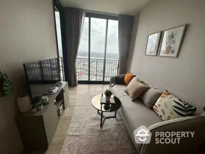 Stylish living room with cozy sofa, modern decor, and stunning city view from large windows.