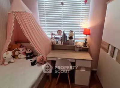 Charming children's bedroom with cozy bed, study desk, and playful decor.