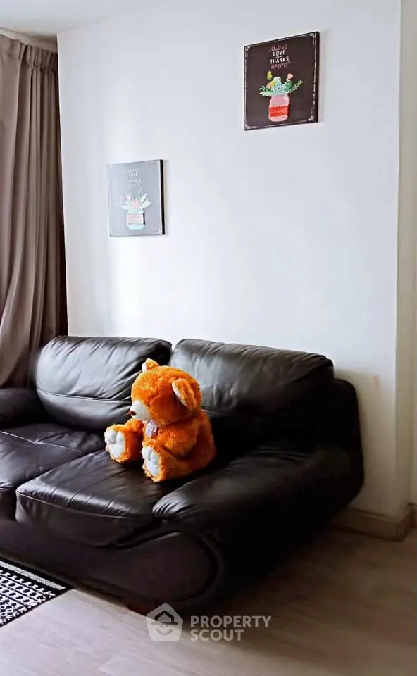 Cozy living room with plush sofa and charming decor, perfect for relaxation.