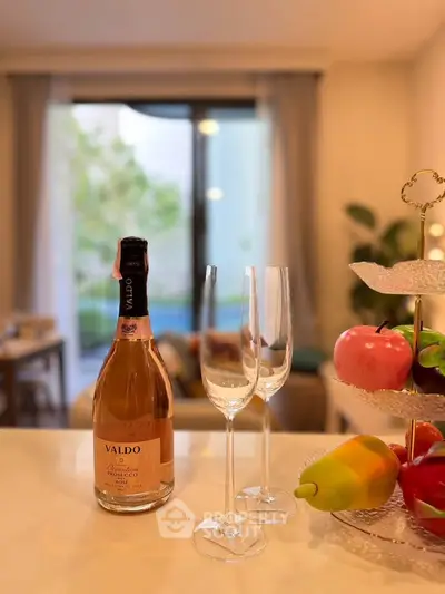 Elegant interior with champagne and fruit display, perfect for entertaining in a modern living space.