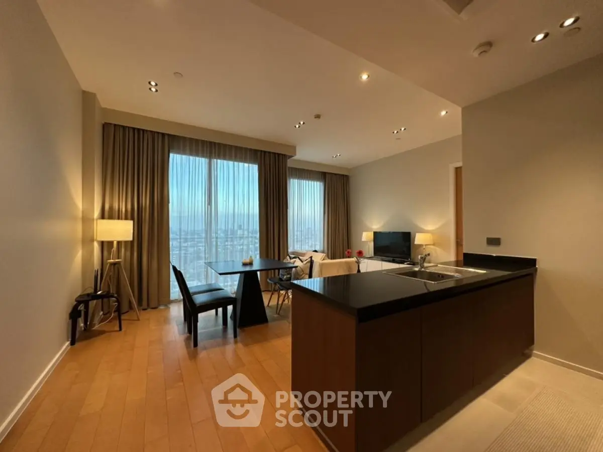 Spacious modern living room with open kitchen and city view