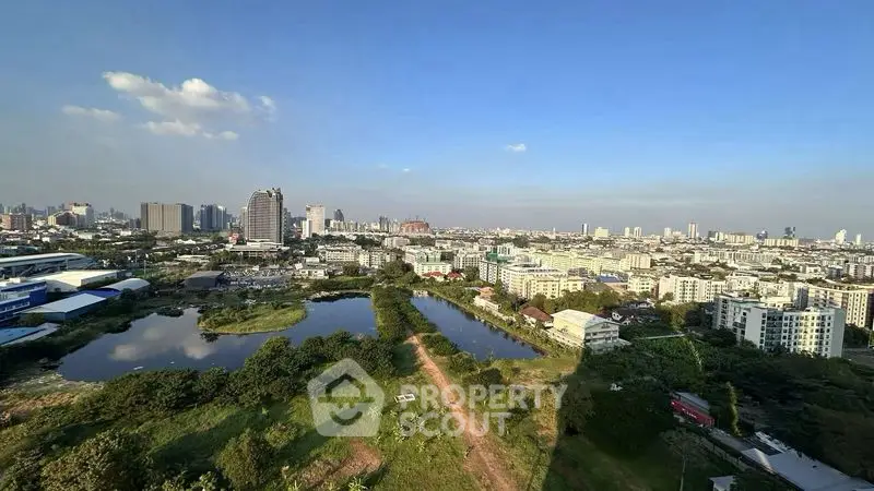 Stunning cityscape view with lush greenery and serene water bodies, perfect for urban living.
