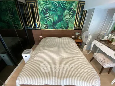 Stylish bedroom with tropical accent wall and modern furnishings