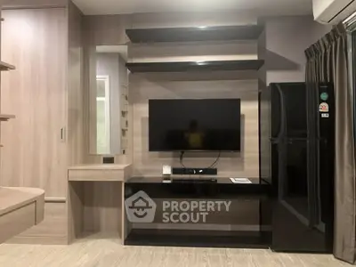 Modern living room with sleek TV setup and stylish shelving, featuring a contemporary design and elegant wood finishes.