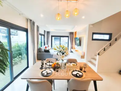 Spacious modern living room with elegant dining area and large windows
