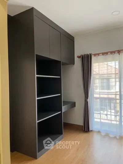 Modern bedroom with built-in storage and balcony view