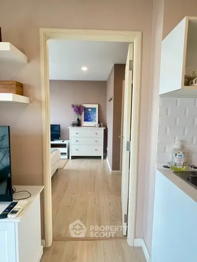 Modern apartment interior with open layout, featuring a cozy living room and stylish kitchen.
