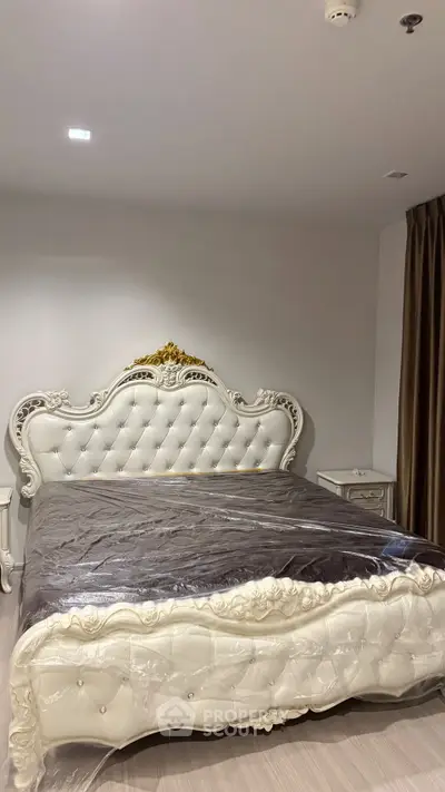 Luxurious bedroom with elegant white tufted bed and classic decor