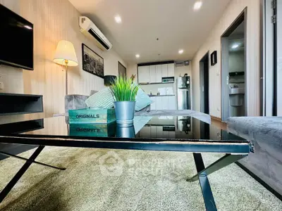 Modern living room with sleek furniture and open kitchen layout