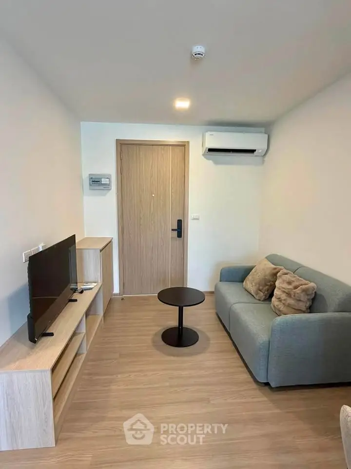Modern living room with sleek furniture and air conditioning in a cozy apartment.