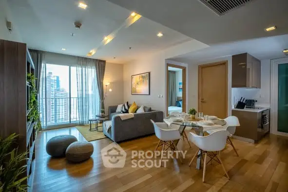 Modern open-plan living room with stylish decor and city view balcony.