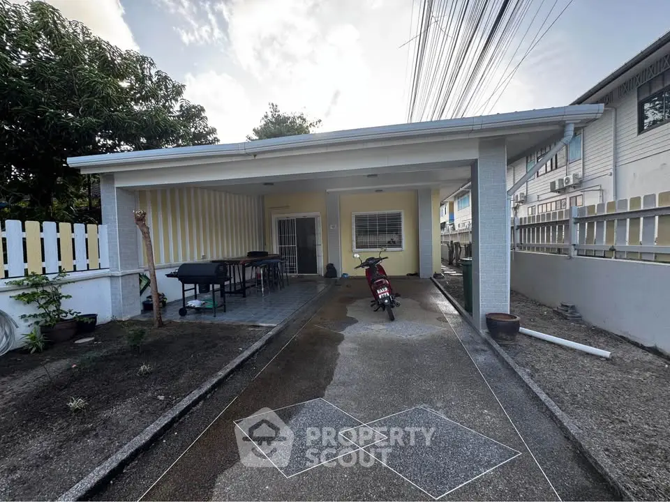 Charming single-story home with covered carport and spacious driveway, perfect for outdoor activities.