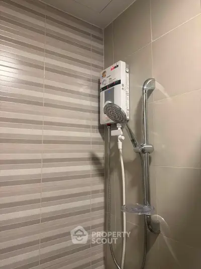 Modern bathroom with sleek shower unit and stylish tile design.