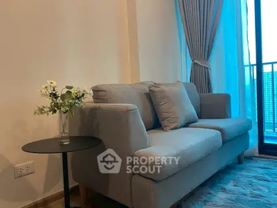 Cozy living room with modern gray sofa and elegant curtains, perfect for relaxation.